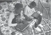  ?? JESSICA HILL/AP ?? In this June 5 photo, fourth grader Sammiayah Thompson, left, and her brother, third grader Nehemiah Thompson, work on laptops provided by their school system for online learning in Hartford. With huge percentage­s of students unplugged from distance learning, educators at schools around the country have been working to understand why.