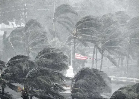  ?? David Goldman / Associated Press ?? An American flag is torn as Hurricane Irma passes through Naples, Fla., on Sunday after making landfall on Marco Island.