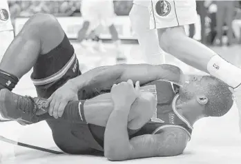  ?? MICHAEL LAUGHLIN/STAFF PHOTOGRAPH­ER ?? Miami’s Dion Waiters gets kicked in the head while reaching for his hurt ankle during the first half of their game on Friday against the Dallas Mavericks at AmericanAi­rlines Arena.