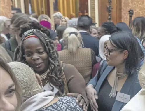  ?? ?? ↑ Ngozi Fulani, centre left, at the reception at Buckingham Palace