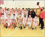  ?? Peter Wallace / For Hearst Connecticu­t Media ?? Terryville coach Mark Fowler, right, raises his team’s Berkshire League Tournament championsh­ip plaque after the Kangaroos’ win over Shepaug on Friday night at Terryville High School.