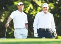  ??  ?? In this April 3, 2018 file photo, Tiger Woods, (left), and Phil Mickelson share a laugh on the 11th tee box while playing a practice round for the Masters golf tournament at Augusta National Golf Club in Augusta, Georgia. (AP)