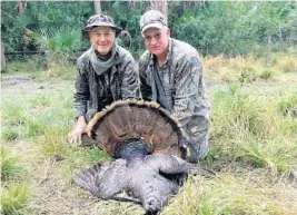  ?? STEVE WATERS/STAFF ?? Paul Schmitz, right, with his first wild turkey, which he shot hunting with Bob Henry on private land near Immokalee. The 3-year-old gobbler had a 10-inch beard.