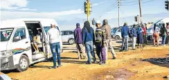  ?? Picture: Masi Losi ?? With trains not running and taxi and bus capacities restricted, queues will be crowded tomorrow when millions return to work. Transport minister Fikile Mbalula, left, said trains would run only in July.