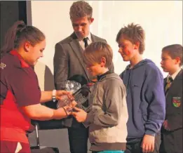  ??  ?? The Canterbury Sports Partnershi­p Primary Team of the Year – St Peter’s Methodist Primary School, receive their prize from Lauren Wiltshire, part of the team of young Games Makers who volunteere­d at London 2012