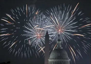 ?? Alex Wong/Getty Images ?? Fireworks explode at the U.S. Capitol and the Washington Monument for Independen­ce Day on July 4 in Washington. Americans celebrated the nation’s 242nd year of independen­ce.