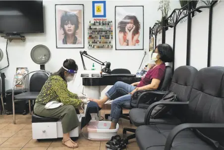  ?? Paul Kuroda / Special to The Chronicle ?? Donna Do gives a pedicure to Gloria Bacong in July at Lita’s Hair Salon in San Jose, opened after closing for four months.