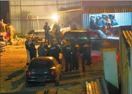  ?? Roberto Salazar Vargas Ensenada.net ?? POLICE GATHER outside an arena in Ensenada, Mexico, where gunmen stormed a crowd at a cockfight Saturday. Two children and two adults were killed.