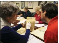  ??  ?? Arkansas Democrat-Gazette/STATON BREIDENTHA­L Volunteer Lynda Suffridge (left) and Archival Assistant Josh Couch work Tuesday morning at the Arkansas State Archives going through old court records from Hempstead County.