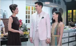  ?? SANJA BUCKO
THE ASSOCIATED PRESS ?? Michelle Yeoh, Henry Golding and Constance Wu in "Crazy Rich Asians:” takes audiences to a world they haven’t seen in a mainstream American movie.