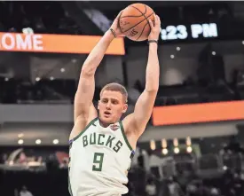  ?? MICHAEL SEARS/MILWAUKEE JOURNAL SENTINEL ?? Bucks rookie Donte DiVincenzo pulls down one of his seven rebounds against the Bulls on Wednesday.