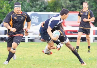  ?? PICTURE / DEBBIE BEADLE ?? THE COLD SHOULDER: Isimeli Tagea from Awanui drives a Northern Wairoa Rodney player back during the Harding Shield final at Dargaville on Saturday. Northern Wairoa Rodney won 52-10.