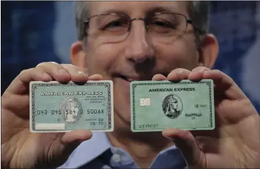  ?? BEBETO MATTHEWS — ASSOCIATED PRESS ?? Ira Galtman, American Express director of corporate archives, shows the original American Express “Green Card,” left, with its latest version in New York. Analysts say a change was overdue because the card’s popularity has been in decline.