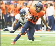  ?? Rich Barnes / Getty Images ?? Syracuse’s Sean Riley runs with the ball after a catch in front of UConn’s Omar Fortt on Saturday.