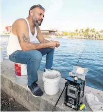  ?? JOHN MCCALL/SOUTH
FLORIDA SUN SENTINEL ?? Luis Zuniga fishes in Hollywood on Thursday.