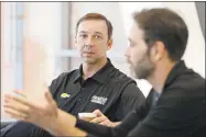  ?? Chuck Burton / Associated Press ?? NASCAR crew chief Chad Knaus, left, listens as driver Jimmie Johnson, right, speaks to the media during a news conference in Charlotte, N.C., on Thursday.