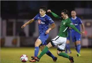  ??  ?? Dylan Barnett of Waterford is tackled by Daniel McKenna of Bray Wanderers.