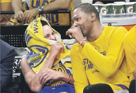  ?? Ronald Cortes Associated Press ?? STEPHEN CURRY, left, and Kevin Durant have enjoyed Golden State’s romp to the Finals. The Warriors are 12-0 in the playoffs.