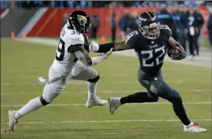  ?? AP PHOTO/ JAMES KENNEY ?? Tennessee Titans running back Derrick Henry (22) runs against Jacksonvil­le Jaguars free safety Tashaun Gipson (39) during the second half of an NFL game Thursday in Nashville, Tenn. The Tennessee Titans won 30-9.