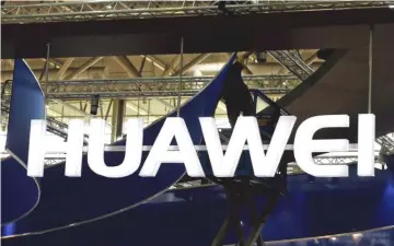  ??  ?? A worker adjusts the logo at the stand of Huawei at the CeBIT trade fair in Hanover, in this file picture. China’s Huawei, the world’s largest maker of telecommun­ication network equipment, does not see itself becoming the target of US sanctions and...