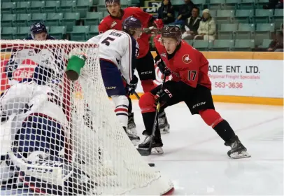  ?? CITIZEN PHOTO BY JAMES DOYLE ?? Prince George Cougars defenceman Jack Sander cuts hard to the net guarded by Tri-City Americans goaltender Beck Warm during Tuesday night’s WHL game at CN Centre.