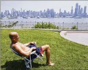  ?? SETH WENIG / ASSOCIATED PRESS ?? Rick Stewart sits in the sun in a park in Weehawken, N.J. According to weather records released on Wednesday, May reached a record average 65.4 degrees in the continenta­l United States — 5.2 degrees above the 20th century average.