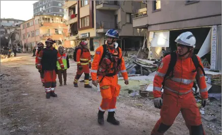  ?? The Associated Press ?? Members of the British rescue team scout the destroyed buildings in Antakya, southern Turkey. Rescue workers made a final push Thursday to find survivors of the catastroph­ic earthquake in Turkey and Syria that rendered many communitie­s unrecogniz­able.