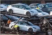  ?? CARLOS BARRIA / REUTERS ?? Tesla Model 3 vehicles are seen for sale at a Tesla facility in Fremont, California, on May 23.