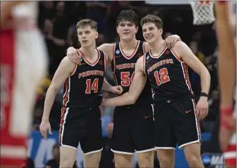  ?? AP PHOTO/JOSÉ LUIS VILLEGAS ?? Princeton guard Matt Allocco (14) forward Zach Martini (54) and forward Caden Pierce (12) and teammates embrace in the final seconds of the second half of a first-round college basketball game against Arizona in the NCAA Tournament in Sacramento, Calif., Thursday, March 16, 2023. Princeton won 59-55.