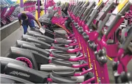  ?? PATRICK T. FALLON AFP VIA GETTY IMAGES ?? A Planet Fitness employee cleans gym equipment in March in Inglewood. The CDC says it’s rare to transmit the coronaviru­s via surfaces.