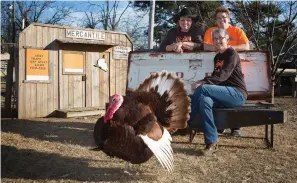  ?? Staff file photo by Evan Lewis ?? ■ Angie Watson, Julie Miller and Dee Dee Rogers, along with Trey the turkey, are the welcoming committee in January 2015 at Three Chicks Feed, Seed, & Cafe.