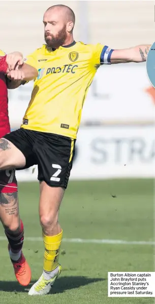  ??  ?? Burton Albion captain John Brayford puts Accrington Stanley’s Ryan Cassidy under pressure last Saturday.