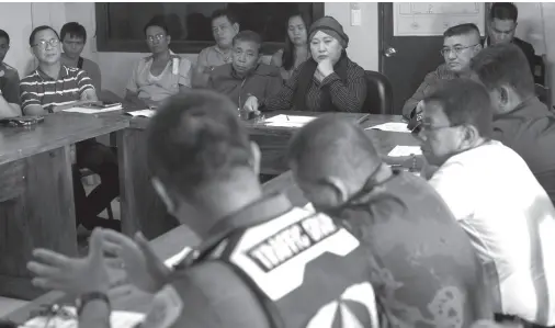  ?? BING GONZALES ?? OFFICIALS of various government agencies discuss with the operators of bus and van companies on the security and safety of passengers in line with Oplan Kaluluwa.