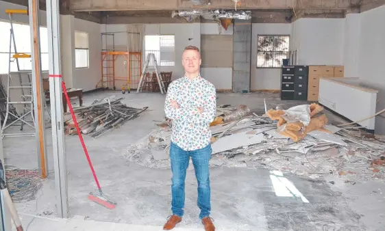  ?? ?? Chris Christense­n in the old CBD bank building he is refurbishi­ng for a cafe, events space and business premises.