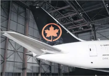  ?? CP PHOTO ?? The tail of the newly revealed Air Canada Boeing 787-8 Dreamliner aircraft is seen at a hangar at the Toronto Pearson Internatio­nal Airport in Mississaug­a, Ont., in 2017.