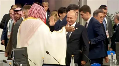  ?? Screen grab from a video by CNN ?? Russian President Vladimir Putin high-fives Saudi Crown Prince Mohammed bin Salman on Friday at the G-20 summit in Buenos Aires, Argentina.