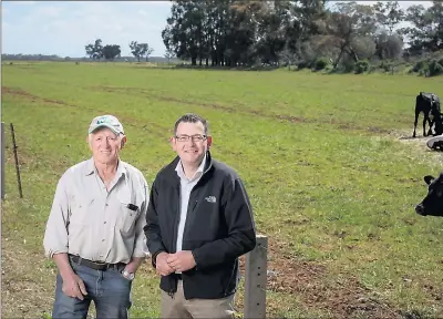  ?? Photo: Sitthixay Ditthavong ?? Dairy farmer Noel Mitchell with premier Daniel Andrews in Lockington on Wednesday.