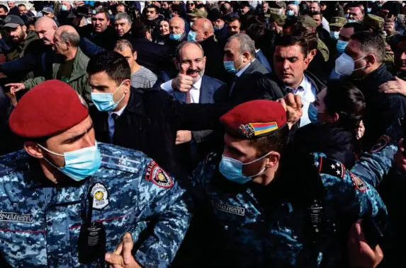  ?? (EPA) ?? Nikol Pashinyan (centre) greets people while walking with his supporters on the streets in downtown Yerevan