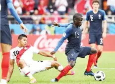  ??  ?? France’s N’Golo Kante and Peru’s Edison Flores vie for the ball. — AFP photo