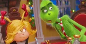  ?? Illuminati­on ?? Cindy-Lou Who (voice of Cameron Seely) helps liberate the Grinch (voice of Benedict Cumberbatc­h) from his grumpiness in “Dr. Seuss’ The Grinch.”