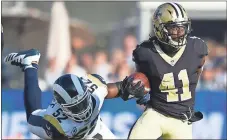  ?? File, Kelvin Kuo / AP ?? New Orleans’ Alvin Kamara (right) runs past Los Angeles’ Alec Ogletree. Kamara was knocked out of the first meeting with the Atlanta Falcons on Dec. 7 with a concussion on the first series of the game.