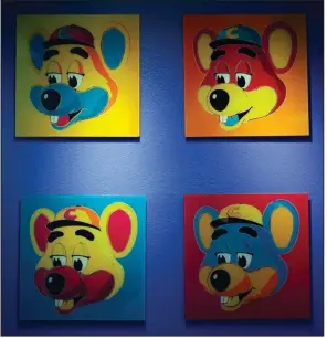  ?? (The Dallas Morning News/G.J. McCarthy) ?? Paintings of Chuck E. Cheese hang on a wall of a franchise in Dallas in this file photo. Chuck E. Cheese pizzeria has filed for bankruptcy protection.