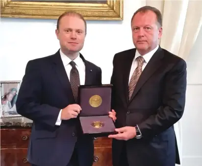  ??  ?? Marius Vizer, right, presenting the gold medal to Prime Minister Joseph Muscat Maria Vella-Gera