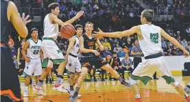  ?? JOHN DENNE/FOR THE NEW MEXICAN ?? Taos’ Quinn Moon threads the needle during Wednesday’s Class 4A quarterfin­al at Santa Ana Star Center. Moriarty beat the Tigers 49-42.