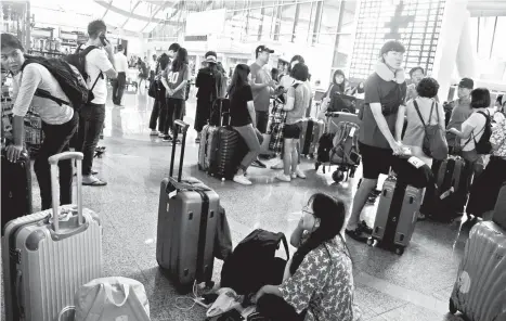  ?? AP ?? DELAYED. Tourists wait as Ngurah Rai Internatio­nal Airport is closed due to the eruption of Mount Agung in Bali, Indonesia, Wednesday, Nov. 29, 2017.