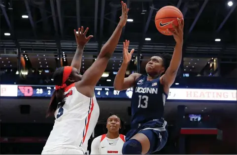  ?? John Minchillo / Associated Press ?? UConn's Christyn Williams shoots against Dayton's Brittany Ward during the second half on Tuesday.