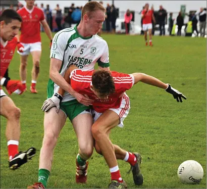  ??  ?? Michael Clarke of Eastern Harps in a battle for possession with Coolera/Strandhill’s Sean Murphy. Pics: Frank O’Sullivan.