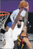  ?? MARK J. TERRILL – THE ASSOCIATED PRESS ?? In his Lakers debut, Damian Jones, left, blocks the shot attempt of Warriors guard Mychal Mulder. Jones had eight points and three rebounds.