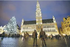  ?? REUTERS ?? BELGIAN SOLDIERS patrol along a Christmas market on Brussels’ Grand Place, Belgium, Dec. 24, 2015.