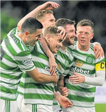  ??  ?? TWO GOOD: James Forrest is mobbed by team-mates after scoring the second goal.